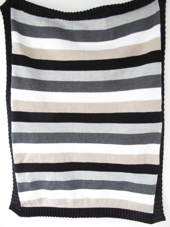 Black white beige and two shades of grey knitted blanket