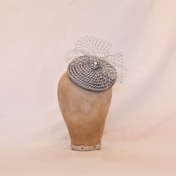 Handmade silver cord coil fascinator with silver veiling and diamanté details
