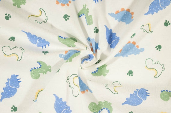 Cute Baby Dinosaurs on Cream Cotton Jersey Knit Fabric