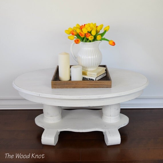 Oval white coffee table. Painted and distressed in white chalk