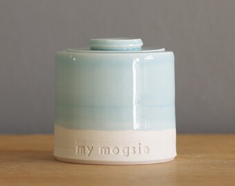 custom urn with lid. Handmade pottery pet urn or human ashes urn. White porcelain, light blue.
