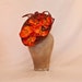 Stunning handmade metallic burnt orange ladies hat decorated with orange orchid flowers handmade in Yorkshire by Jacqueline Walker Millinery Stunning handmade metallic burnt orange ladies hat decorated with orange orchid flowers