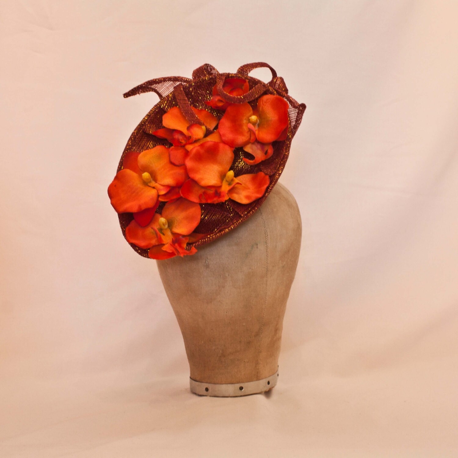 Stunning handmade metallic burnt orange ladies hat decorated with orange orchid flowers