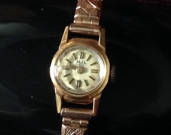 MUDU 18ct gold watch on excalibur bracelet