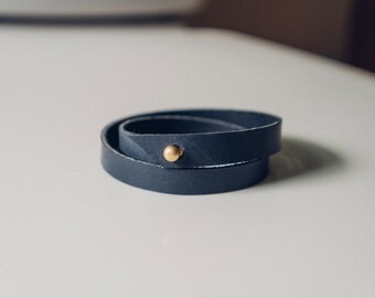 women's customizable wrap bracelet in slate blue // Horween Chromexcel leather with a brass push through fastening system // simple and mini