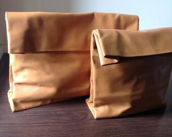 Larger Lunch Bag Leather Clutch with straps. Super soft genuine lambskin sustainable leather clutch.Side rivets and magnetic closure.