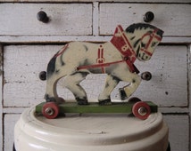 Old vintage wooden horse drawing horse on wheels shabby wooden toys