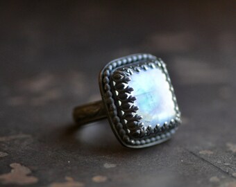 handcrafted moonstone ring set in darkened sterling silver, rectangle stone, pattern wire bezel, flower band, size 6.5