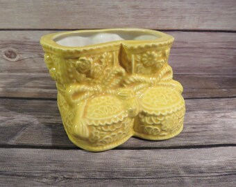 Yellow baby shoe planter