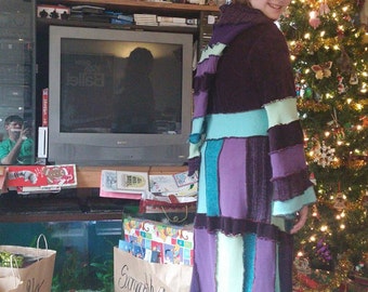 Young lady's sweater coat using purples, teals, and mint green