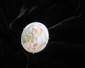 Vintage hand-painted brooch; couple in colonial-era clothing. Silver tone back