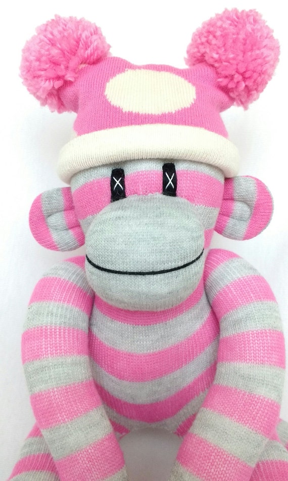 Small pink and grey striped sock monkey with pink and cream