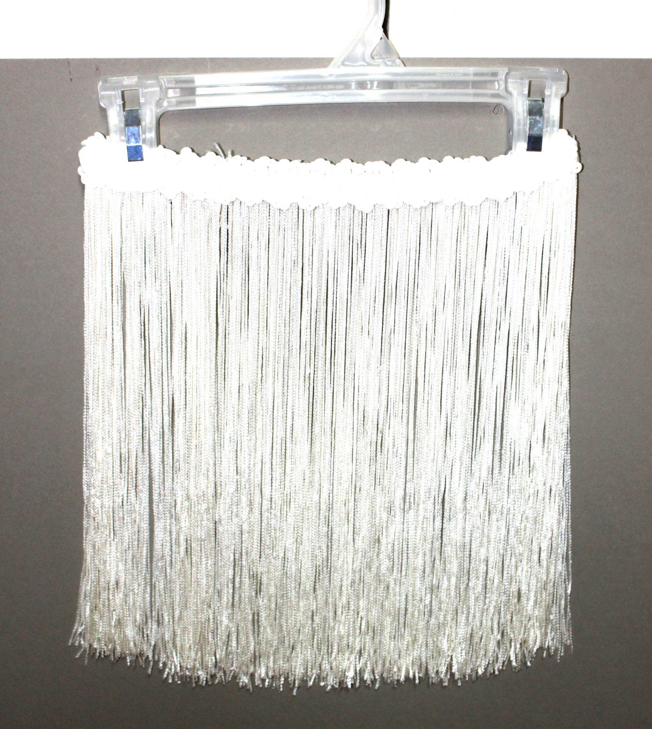 White fringe skirt. Sequin waist band. 12 inch fringe