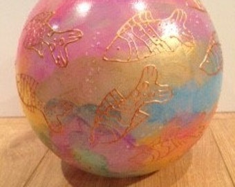Multi coloured glass bowl with fish on.