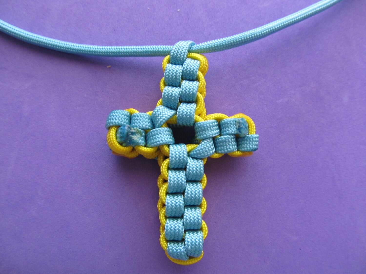 Paracord Cross Necklace. Cross is made from light blue and