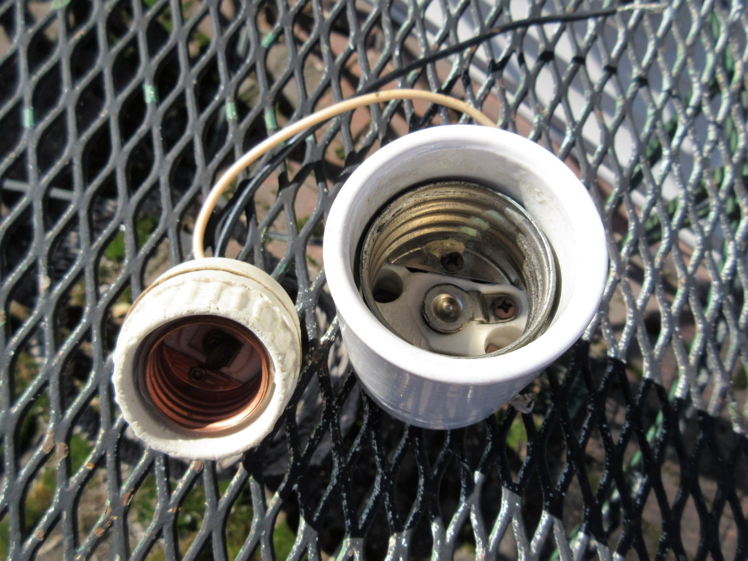 Two porcelain light fixture sockets. one large one standard.