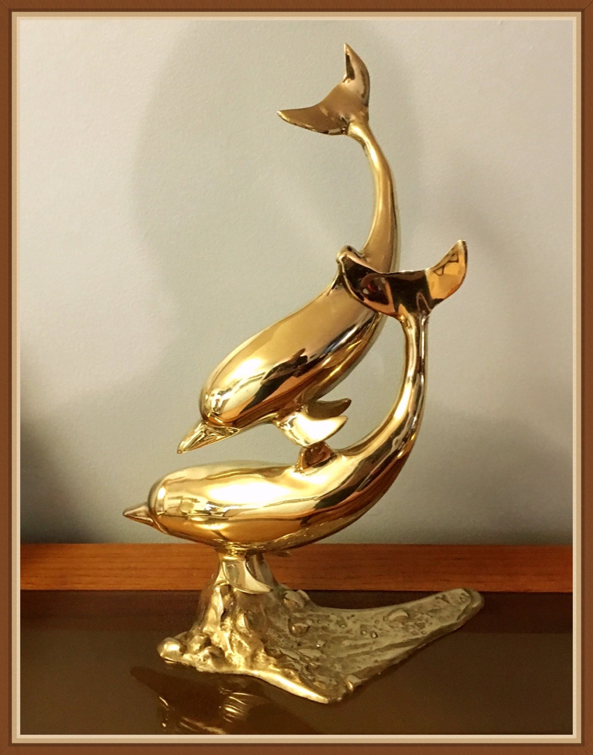 large brass dolphin statue