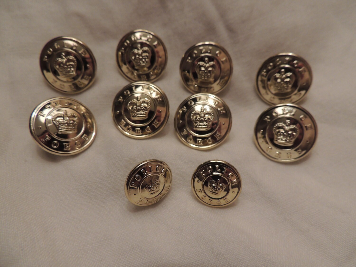 Vintage Golden Canadian police force buttons with royal crown in the ...