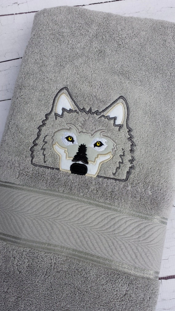 Embroidered wolf bath towel.