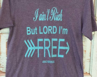 I ain't rich but Lord I'm free. George strait song. Heathered navy vneck with turquoise ink. Unisex fit. District brand tshirt. Small to 3x