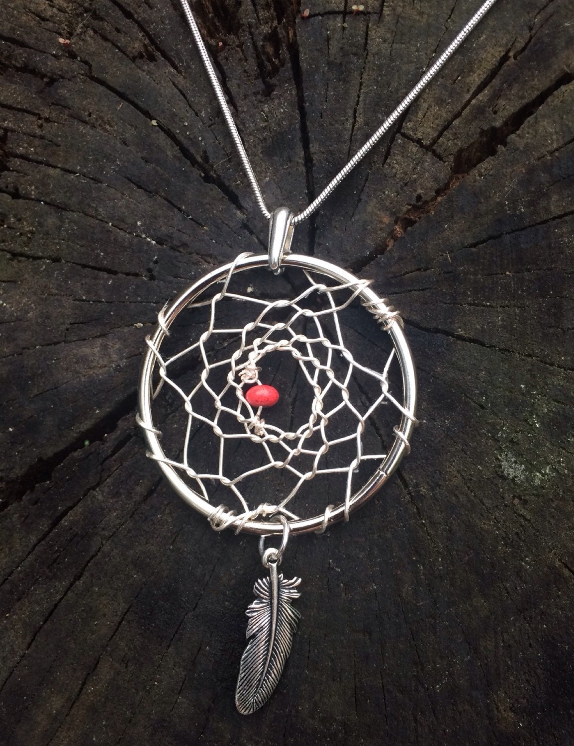 Silver dream catcher pendant with red colored bead