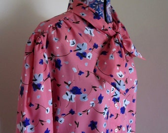 1980s polyester button up blouse, fitted neck tie. MS BOND label. Larger size 20?. Pink with purple floral decoration
