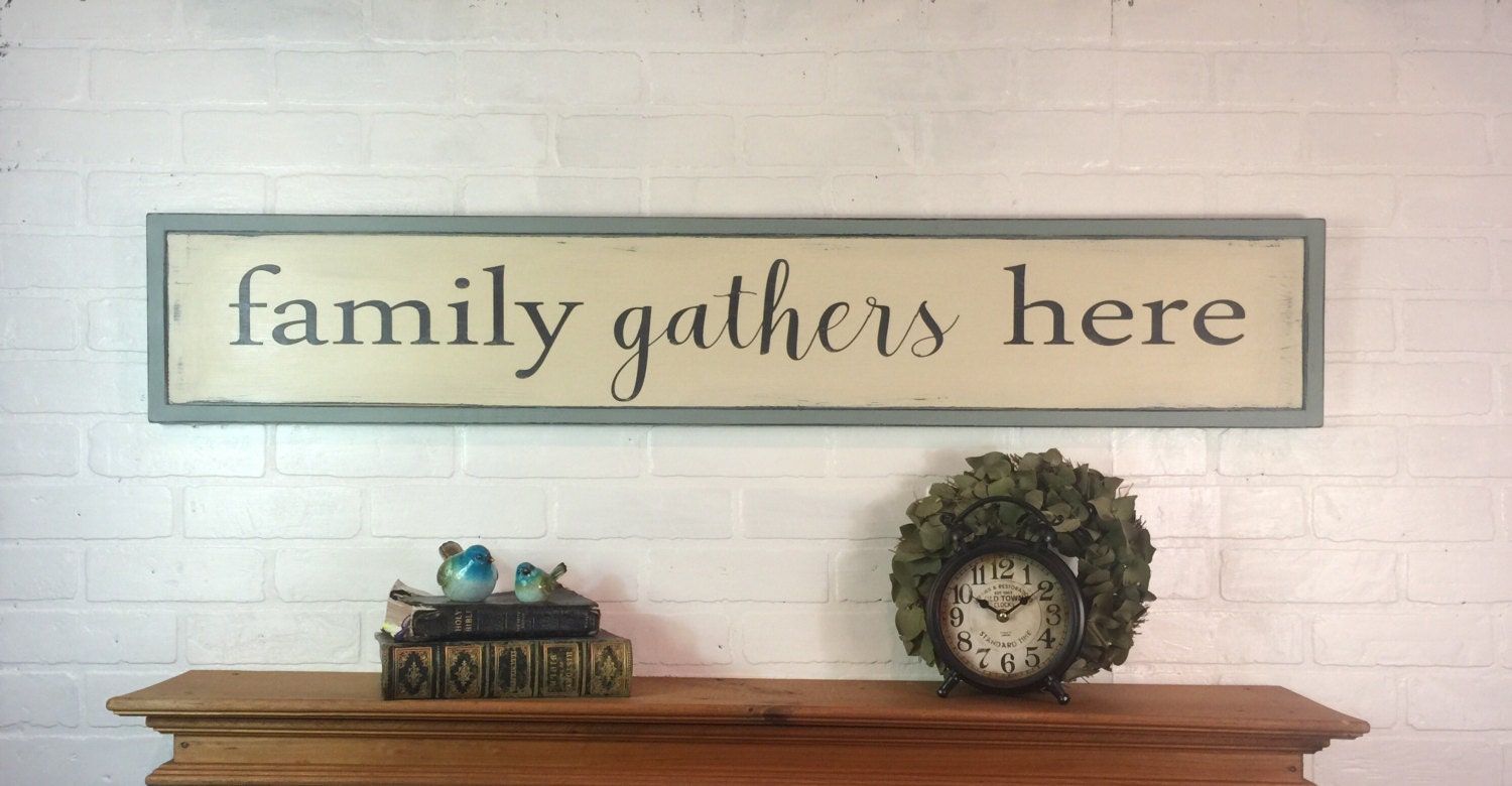 Family gathers here rustic wood framed sign dining room