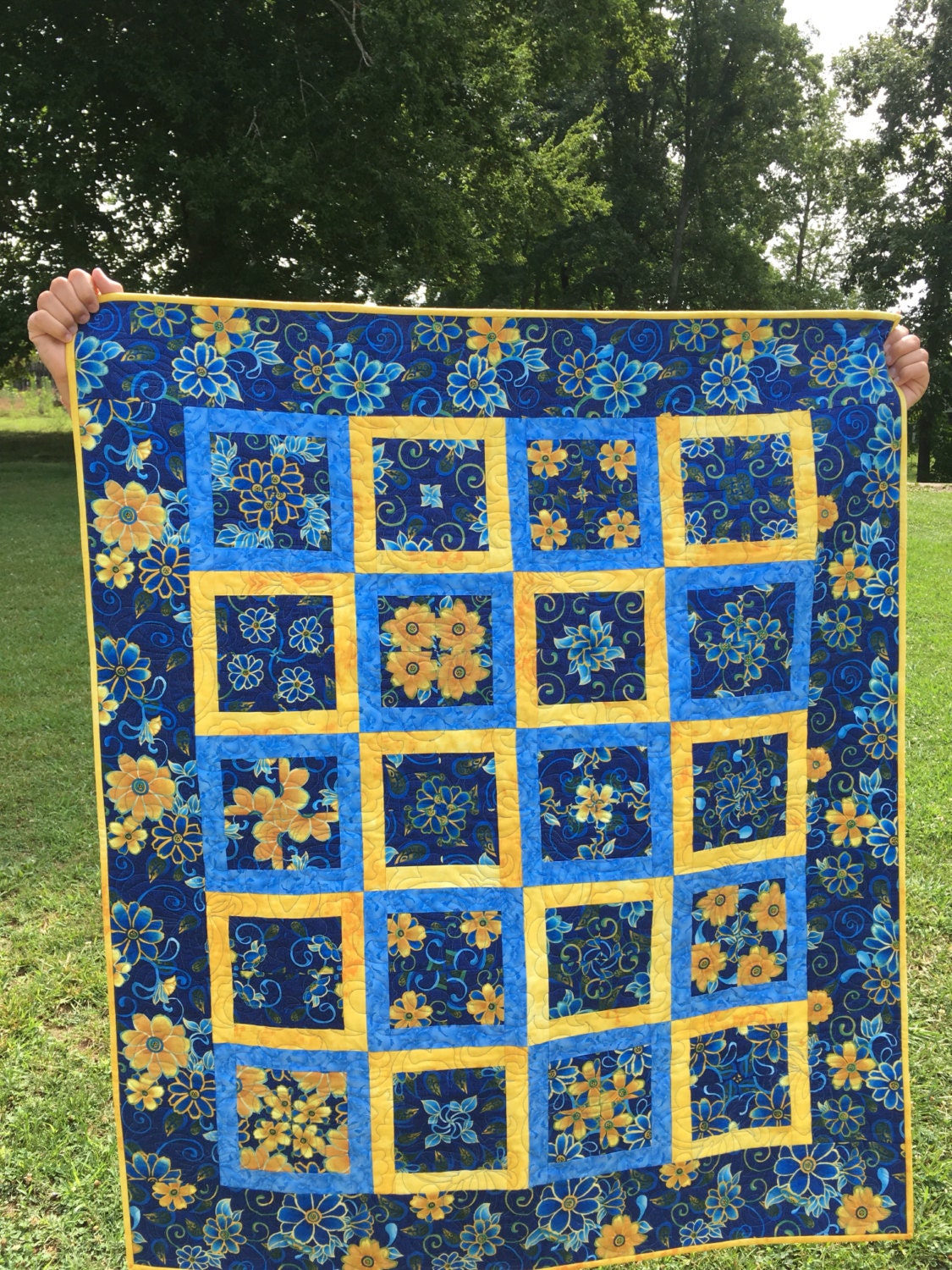 Scrappy blue and yellow quilt with blue flower yellow