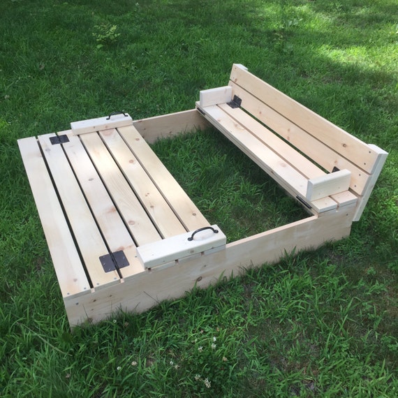 Sandbox with folding cover and built-in benches