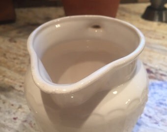 Pretty creamer with raised flower detail