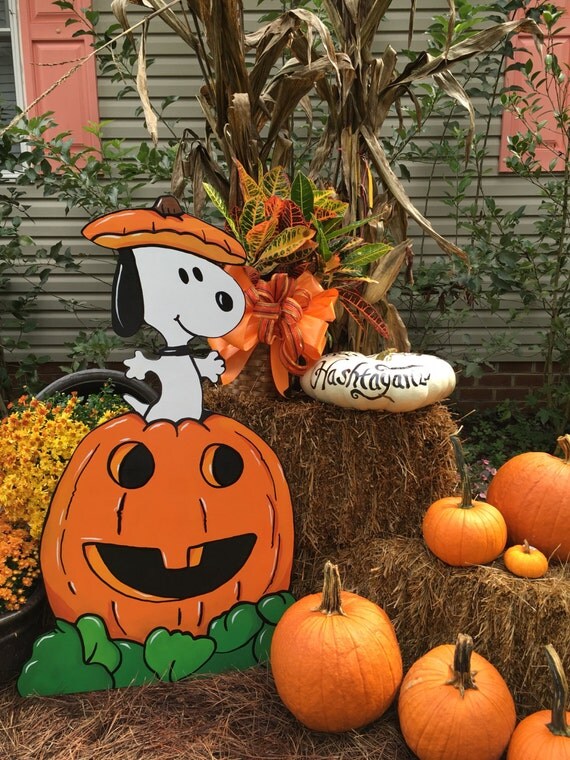 Snoopy jumping out of the pumpkin