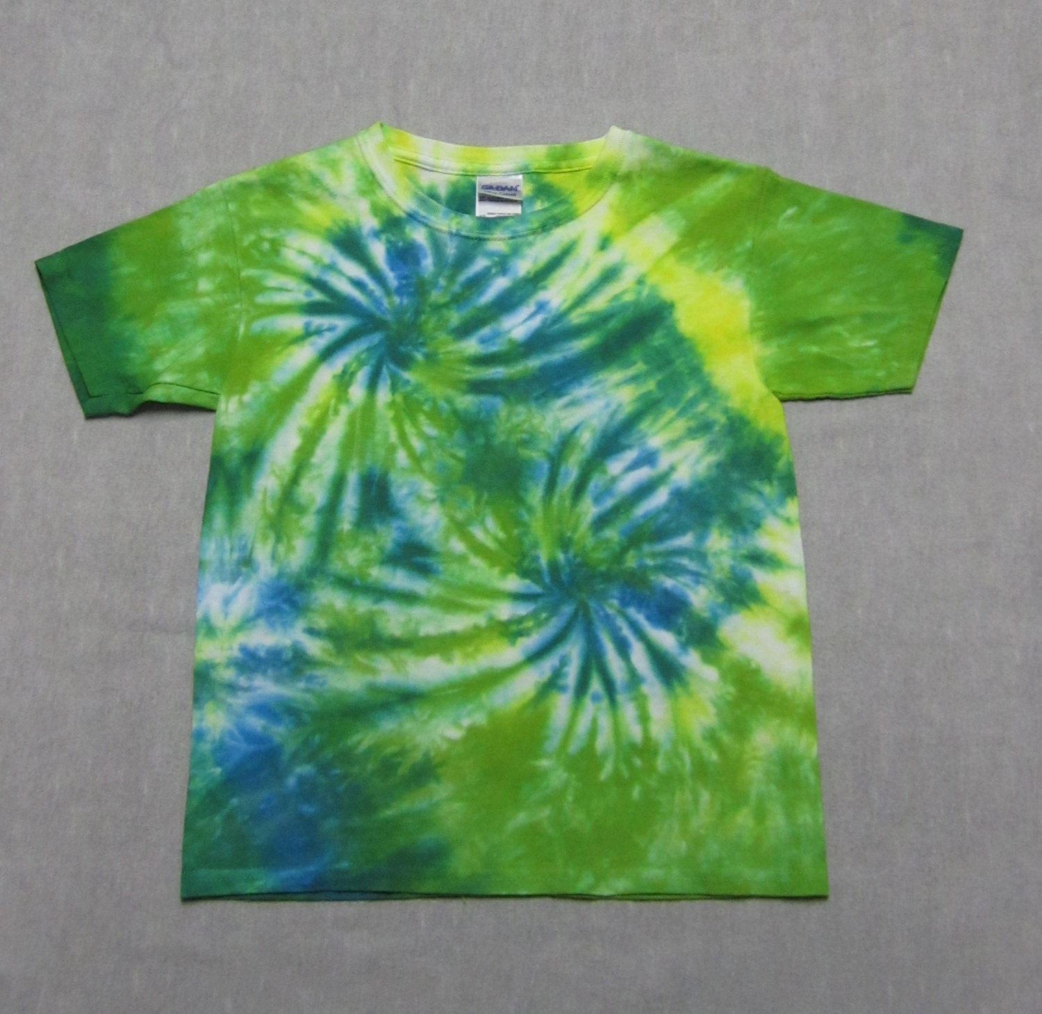 Tie dye youth size XS yellow green and blue spiral tee shirt.