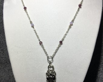 Delicate raven skull necklace.