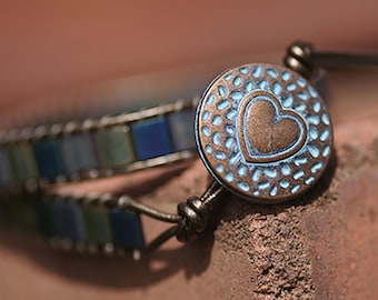 Handmade Miyuki Tila Patina double wrap bracelet with heart pattern button fastening.
