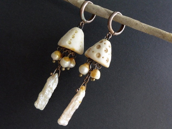 Nepheliad. White ceramic cones and pearl earrings.
