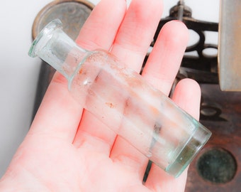 Antique small blue glass bottle, medical or laboratory bottle.