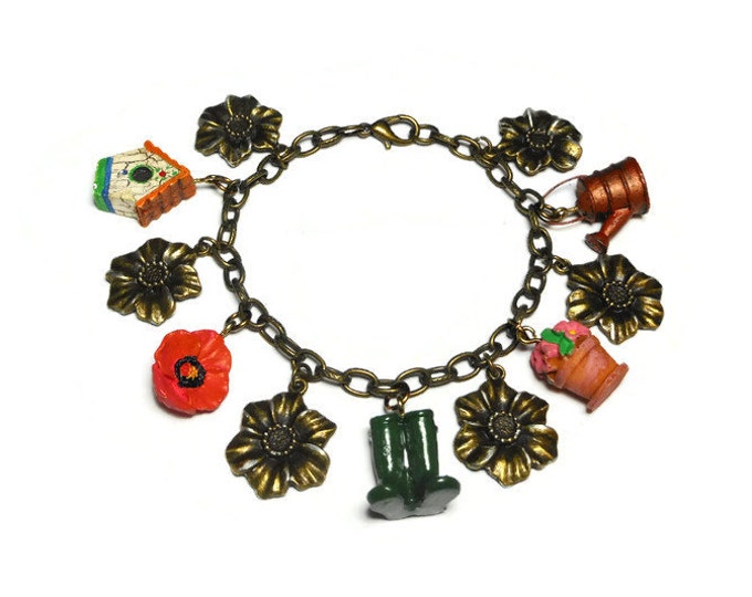 Gardening charm bracelet, upcycled colorful garden charms mixed with bronzed flowers with silver highlights on a bronze link bracelet