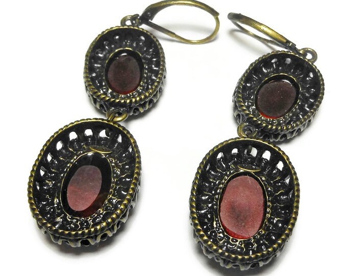 Nina Ricci earrings, dangling opaque red oval cabochons framed in ornate bronze colored metal, lever back earrings, free swinging
