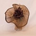 Handmade coffee brown coloured show stopping hat decorated with beading and a silk rose
