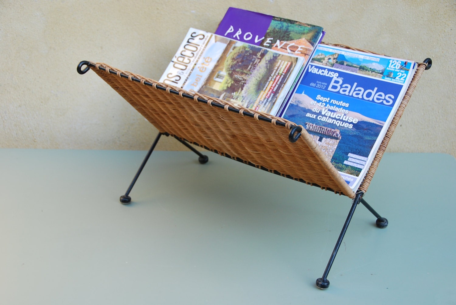 Retro rattan folding magazine rack in typical 1980s style.
