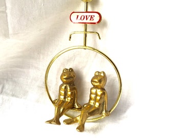 BRASS Frogs on SWING under Love Sign Two Darling Brass Frogs holding hands on bench