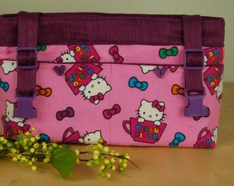 Powerchair-Walker Bag: Bright Pink Hello Kitty Bag with purple lining.