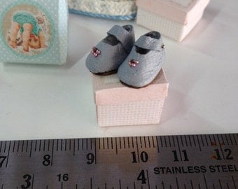 Miniature baby shoes. Dollhouse baby room