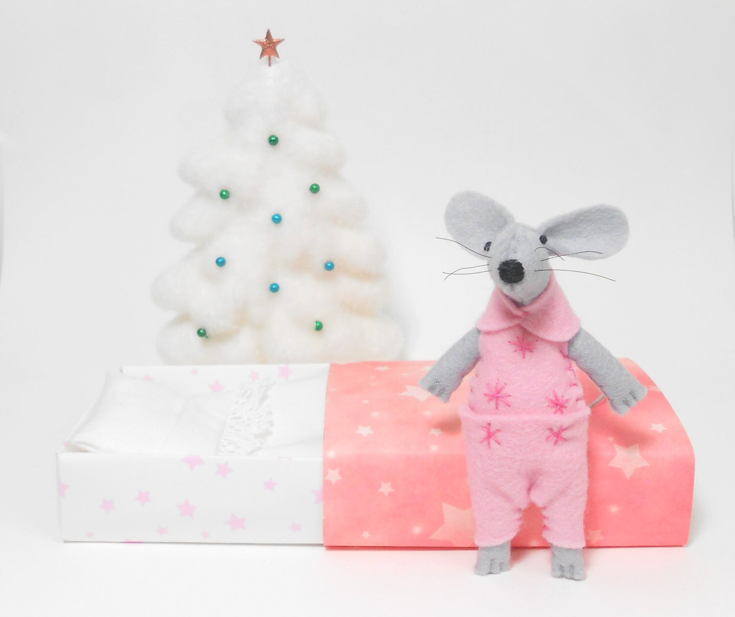 Stuffed felt mouse sleeping in a pink pajamas a starry