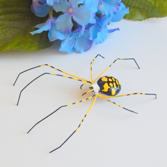 Blue logo yellow writing spider