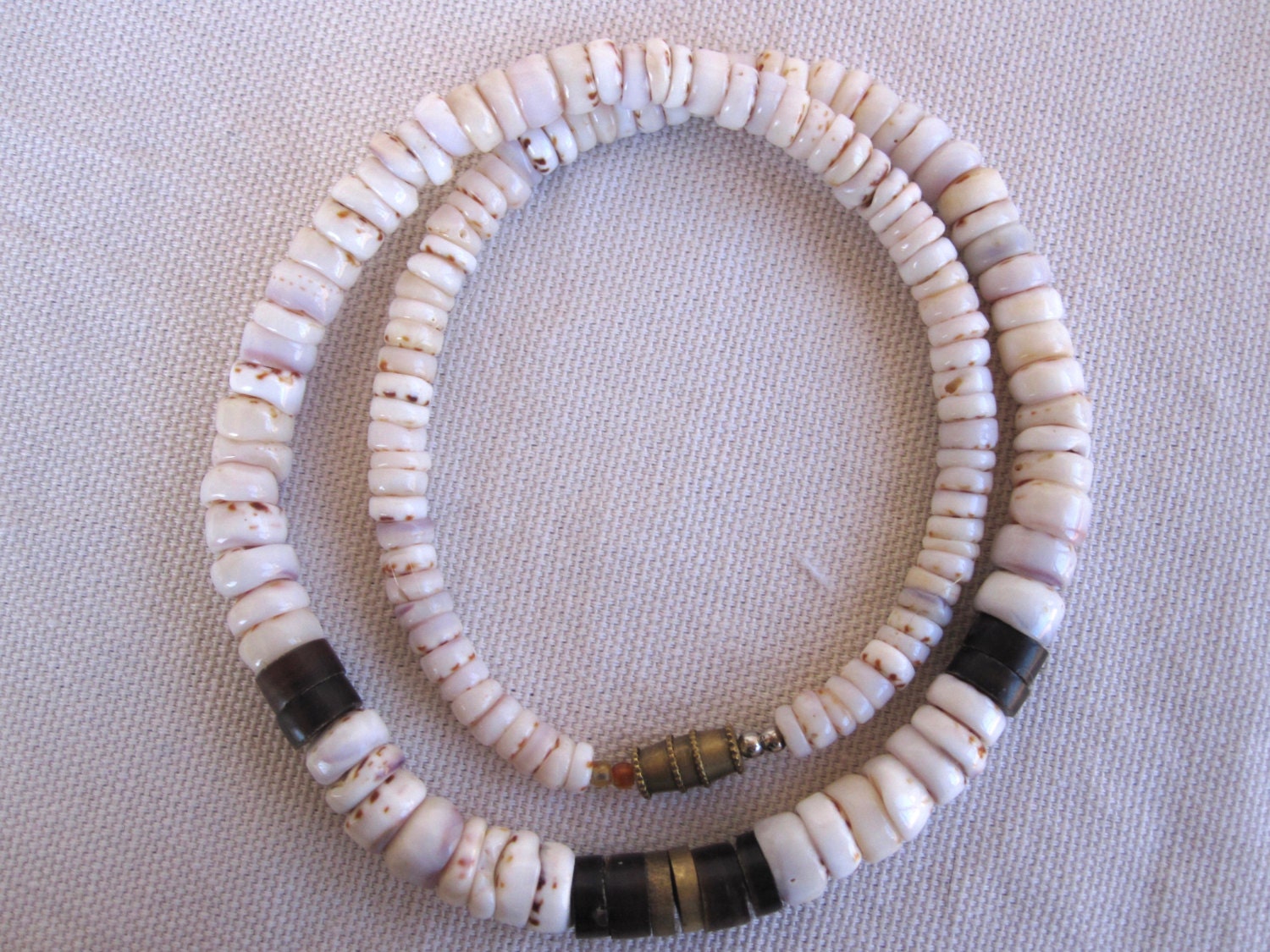 Surfer puka shell necklace with brass accent