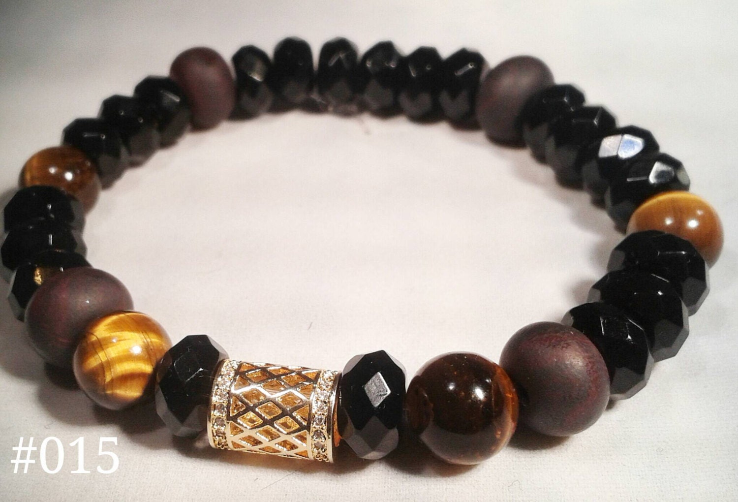 Men's wrist wear.Clay beads on faceted black and Tiger eye