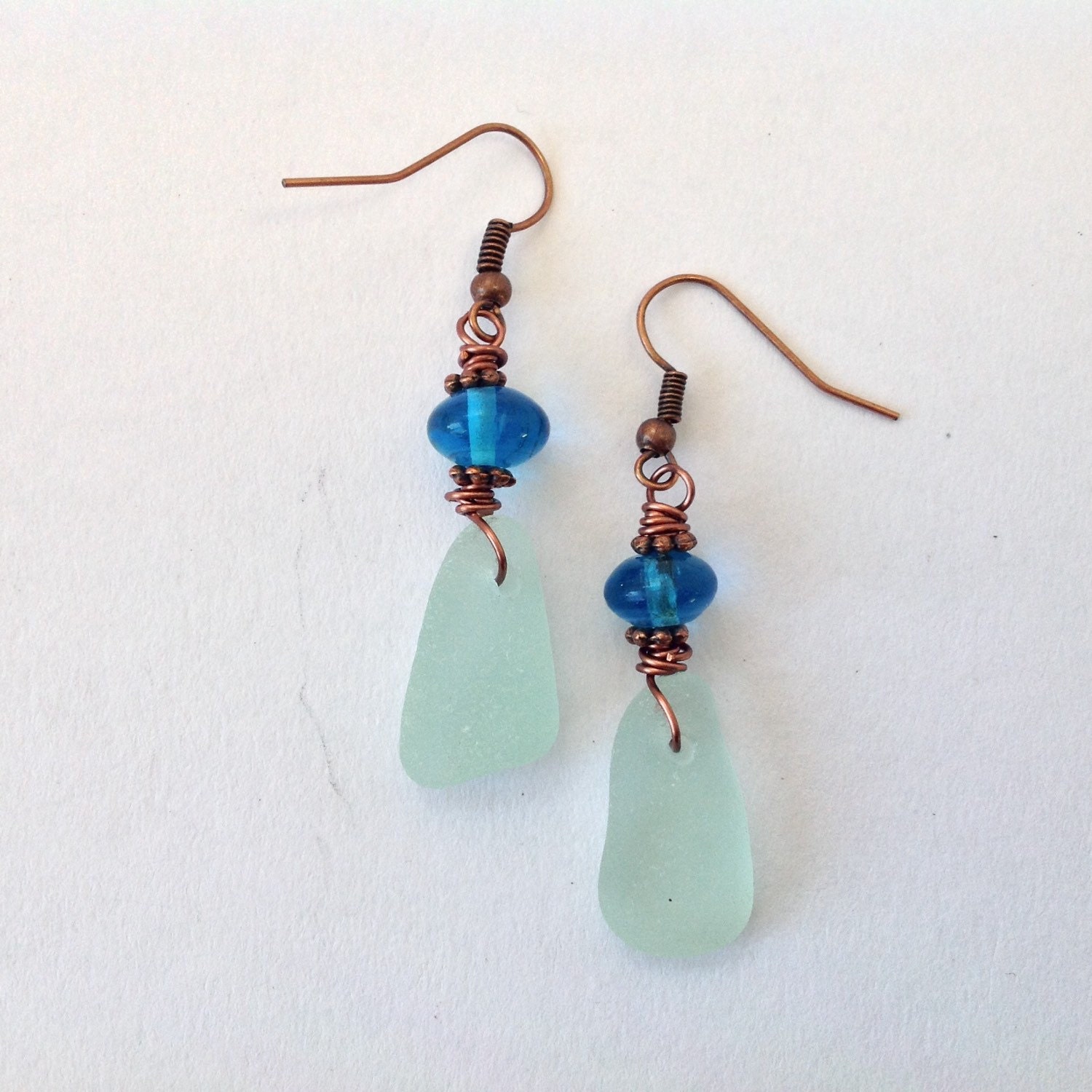 Sea glass earrings with blue glass bead by