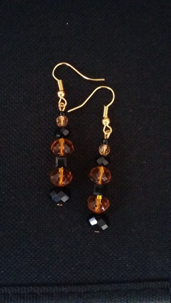 Gold black and amber bead drop earrings