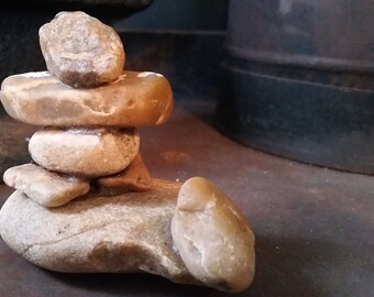 Inukshuk Inuit of stones, Inuksuit Eskimo, with a little animal beside him, River stones, River rock, Pebbles Inukshuk